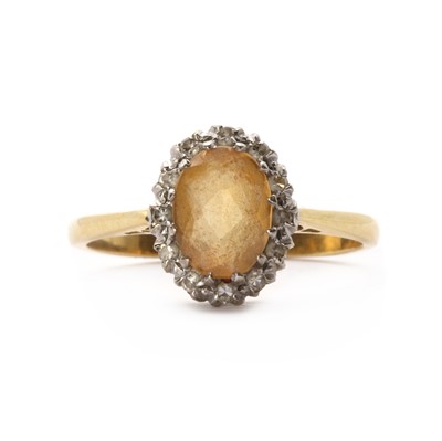 Lot 1216 - A gold yellow topaz and diamond cluster ring