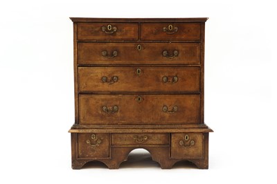 Lot 605 - A walnut chest on stand