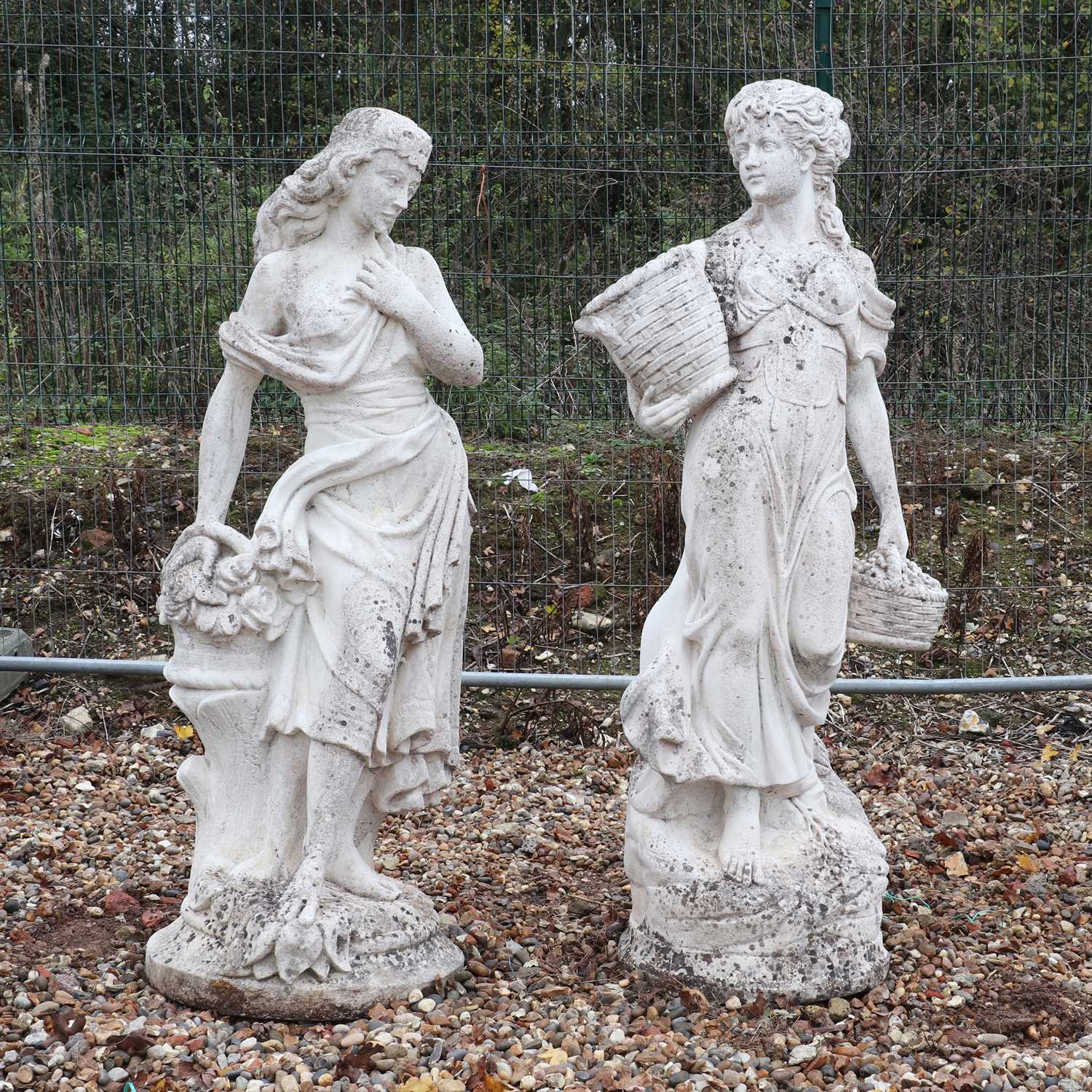 Lot 643 A pair of composite stone garden statues