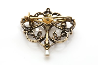 Lot 78 - A late Victorian pearl and diamond scrolling brooch/pendant, c.1890