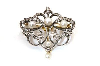 Lot 78 - A late Victorian pearl and diamond scrolling brooch/pendant, c.1890