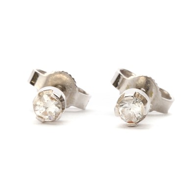 Lot 1161 - A pair of white gold single stone diamond earrings