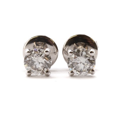 Lot 1158 - A pair of white gold single stone diamond stud earrings