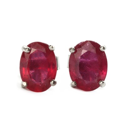 Lot 1188 - A pair of silver fracture filled ruby stud earrings