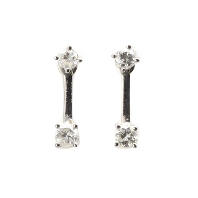 Lot 1162 - A pair of white gold diamond drop earrings