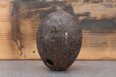 Lot 200 - A carved 'bugbear' coconut flask