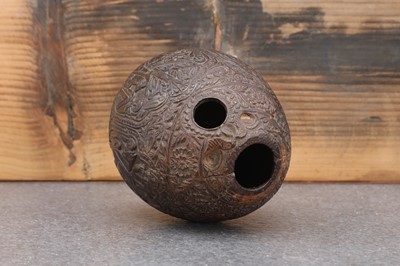 Lot 200 - A carved 'bugbear' coconut flask