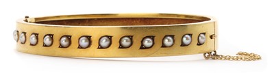 Lot 1027 - A Victorian gold split pearl bangle