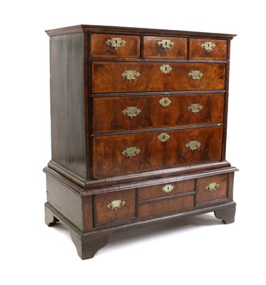 Lot 443 - A walnut chest on stand