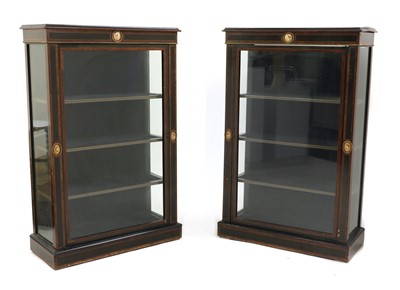 Lot 527 - A pair of ebony and amboyna pier cabinets