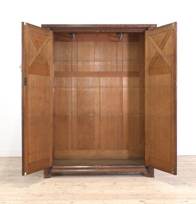 Lot 386 - An Aesthetic Movement oak wardrobe