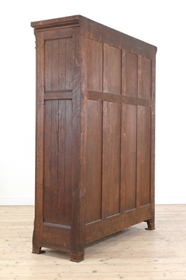 Lot 386 - An Aesthetic Movement oak wardrobe