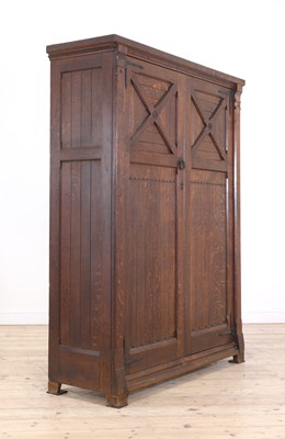 Lot 386 - An Aesthetic Movement oak wardrobe