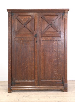 Lot 386 - An Aesthetic Movement oak wardrobe
