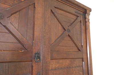 Lot 386 - An Aesthetic Movement oak wardrobe