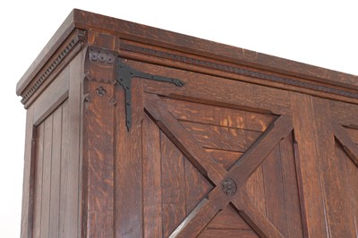 Lot 386 - An Aesthetic Movement oak wardrobe