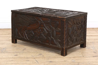 Lot 212 - A carved African coffer