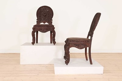 Lot 551 - A pair of carved teak chairs