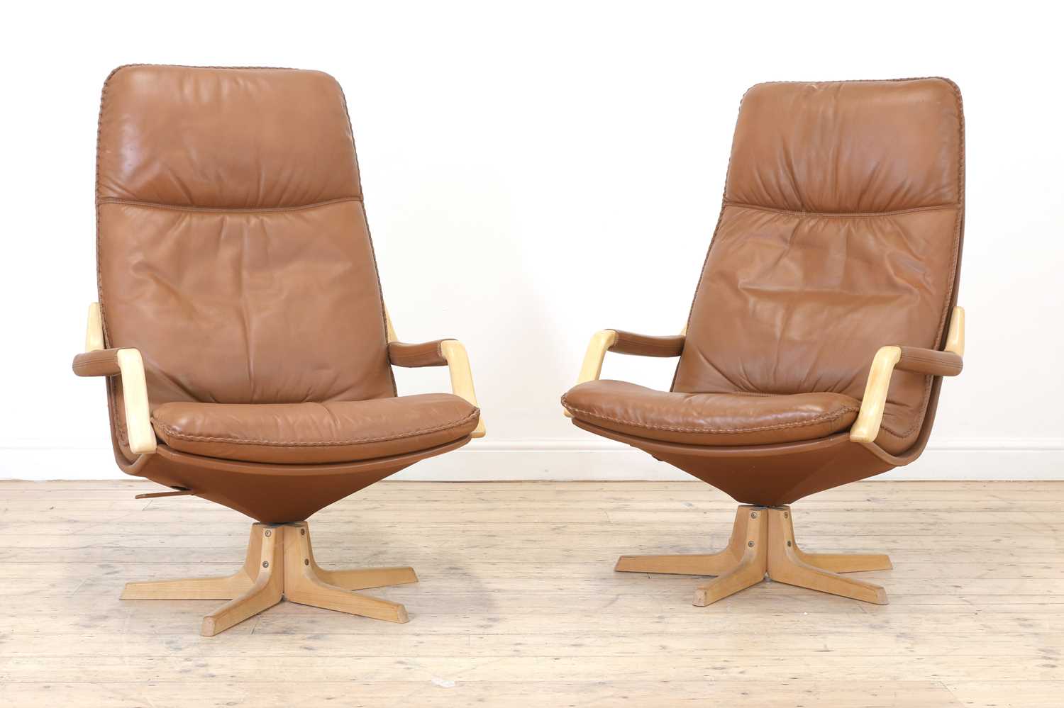 Lot 343 - A pair of Swedish tan leather loungers