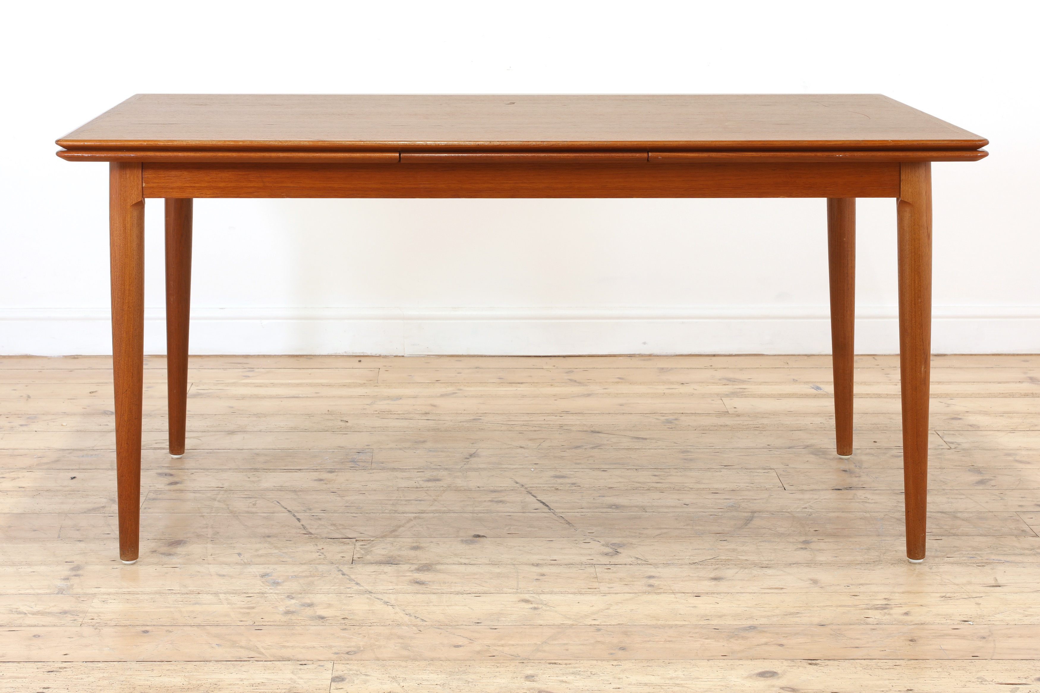 Lot 376 A Danish teak drawleaf dining table and six