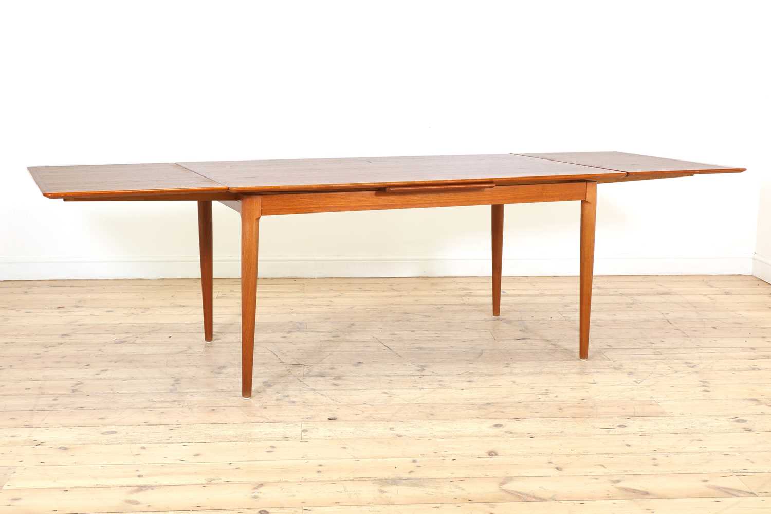 Lot 376 A Danish teak drawleaf dining table and six