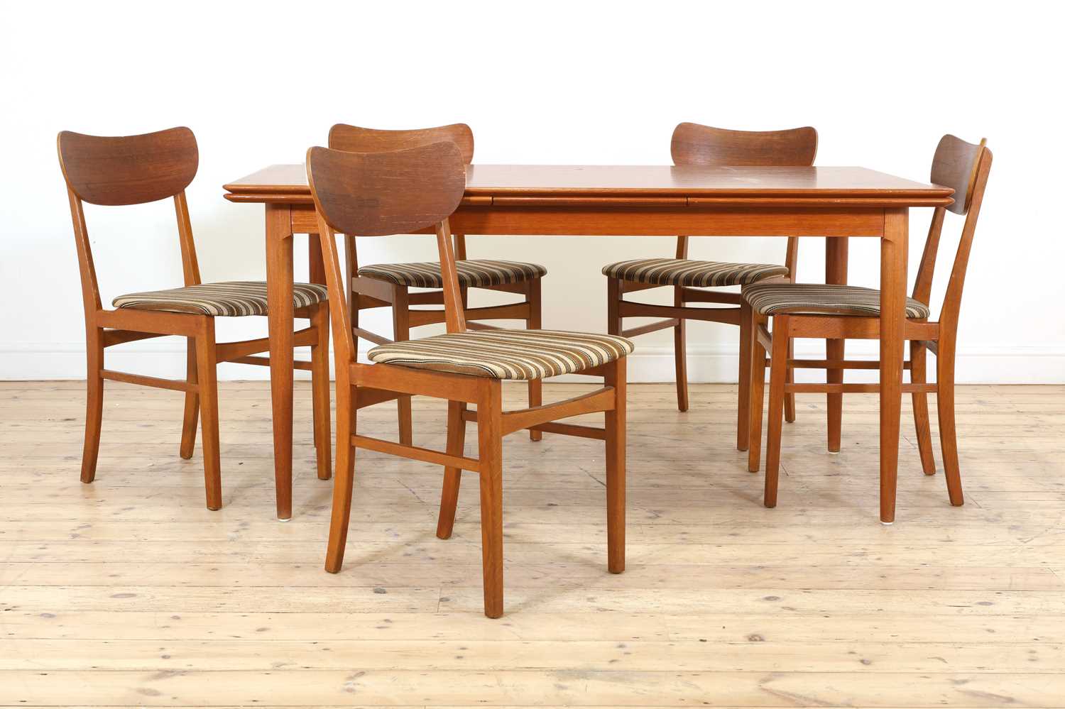 Lot 376 A Danish teak drawleaf dining table and six
