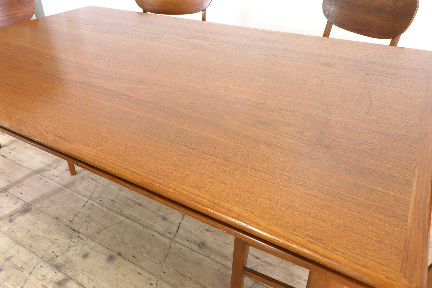 Lot 376 A Danish teak drawleaf dining table and six