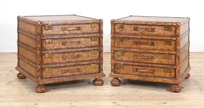 Lot 556 - A pair of leather and brass-mounted bedside chests