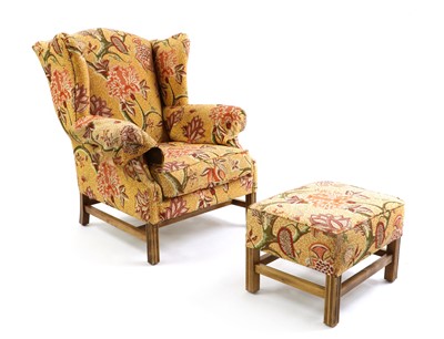 Lot 563 - A George III style wing armchair and footstool