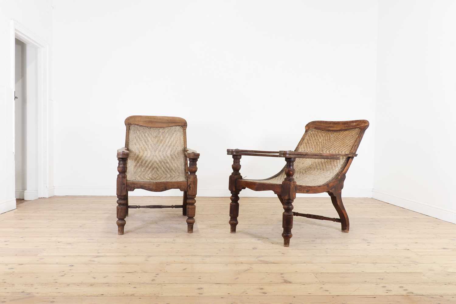 Lot 305 - A near pair of teak planters' chairs