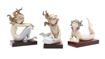Lot 368 - A set of three Lladro porcelain mermaids