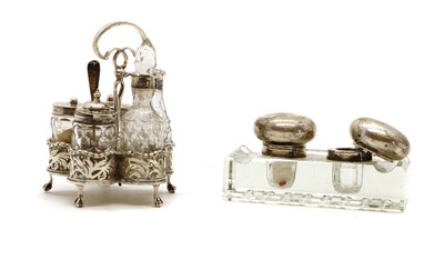 Lot 30 - A silver cruet stand containing five silver mounted glass bottles