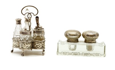 Lot 30 - A silver cruet stand containing five silver mounted glass bottles