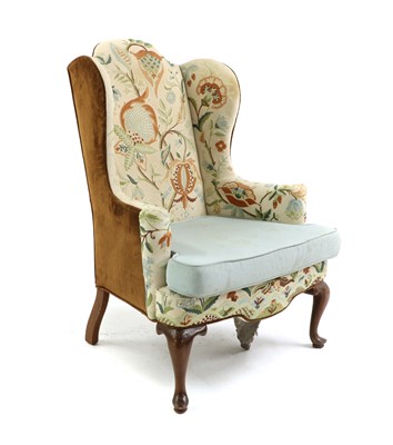 Lot 555 - A wing armchair