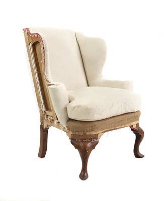 Lot 558 - A Queen Anne style walnut wing armchair