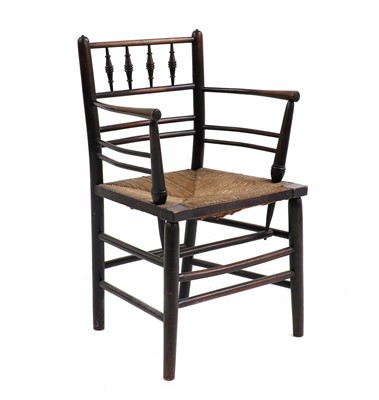 Lot 443 - An Arts & Crafts ebonised Sussex chair