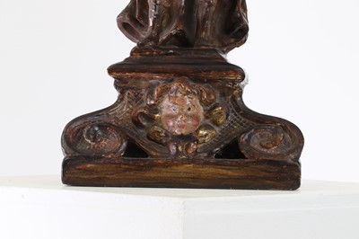 Lot 5 - A carved and polychrome painted candleholder