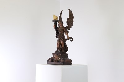 Lot 5 - A carved and polychrome painted candleholder