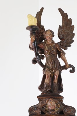 Lot 5 - A carved and polychrome painted candleholder