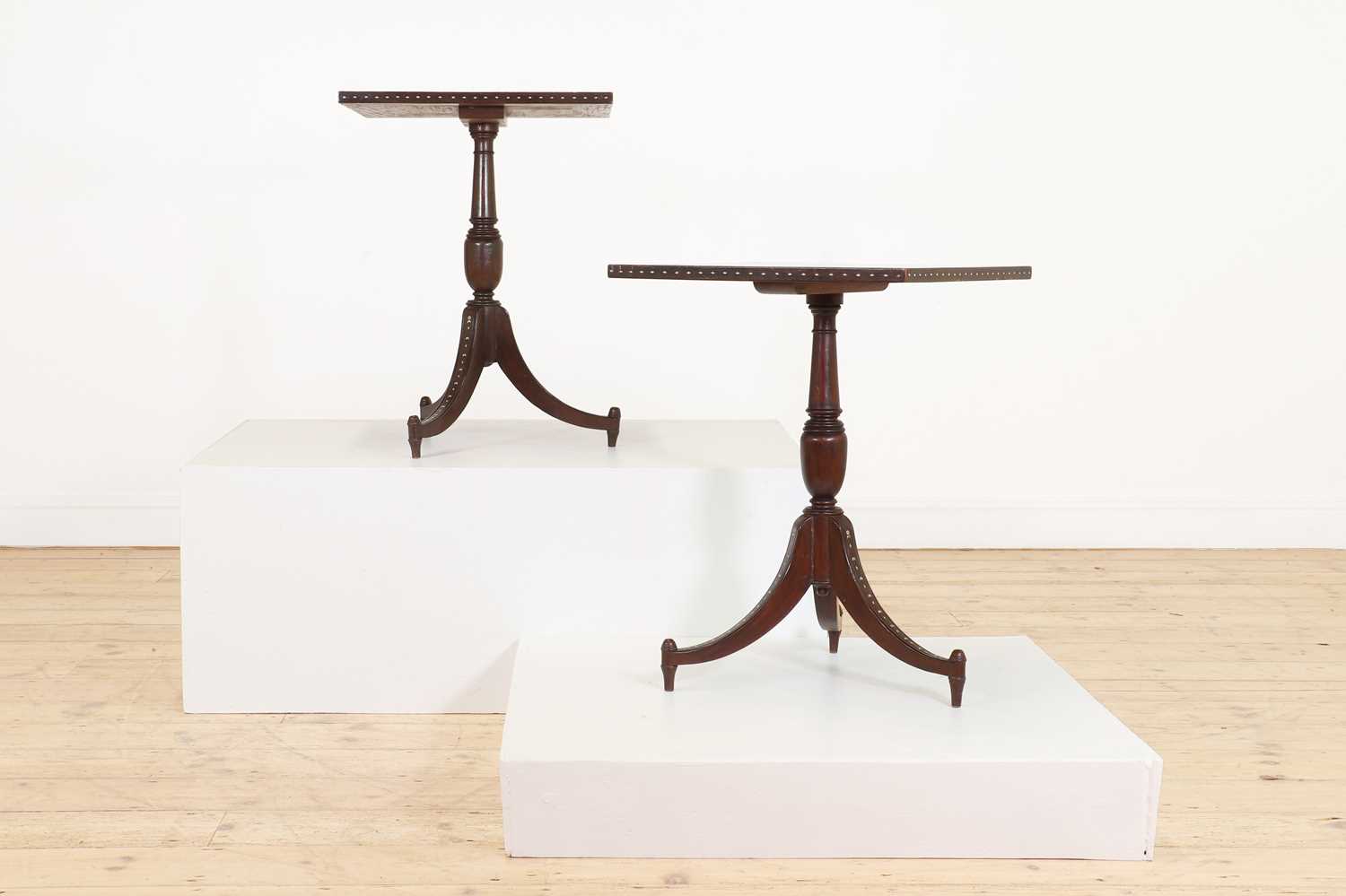 Lot 24 - A pair of teak tripod occasional tables