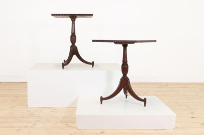 Lot 24 - A pair of teak tripod occasional tables