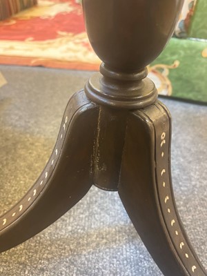 Lot 24 - A pair of teak tripod occasional tables