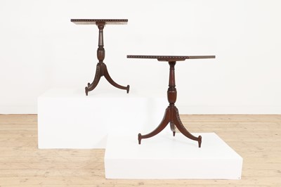 Lot 24 - A pair of teak tripod occasional tables