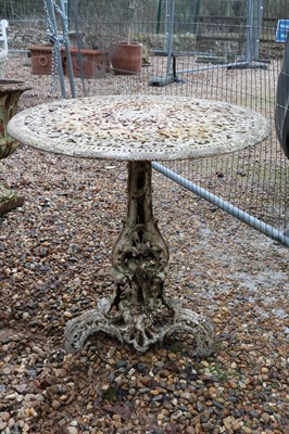 Lot 544 - A cast iron garden table