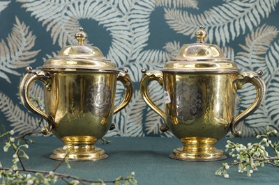 Lot 243 - A George I and later composed pair of silver-gilt cups and covers
