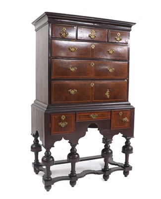 Lot 381 - A walnut chest on stand