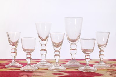 Lot 377 - A suite of George II-style baluster glasses