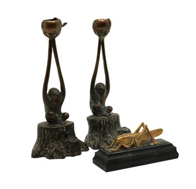Lot 323 - A pair of cast brass candlesticks