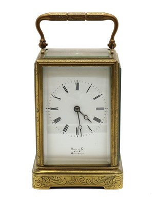 Lot 301 - An engraved brass carriage clock