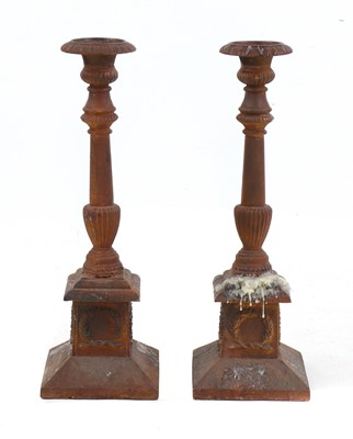 Lot 213 - A pair of cast iron candlesticks